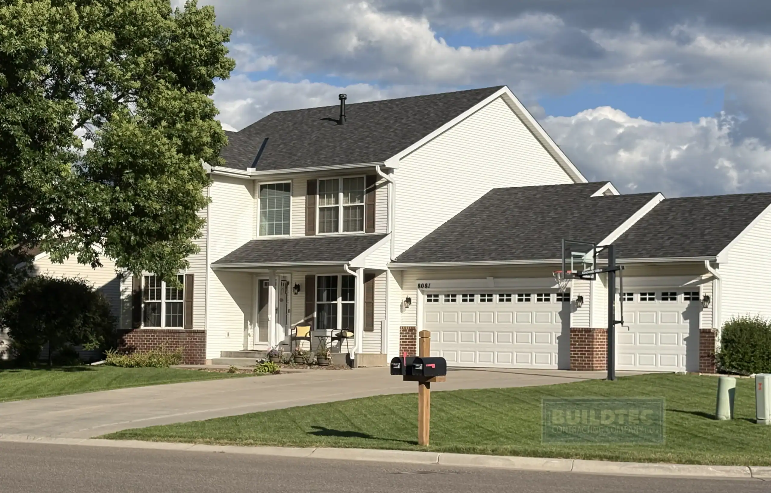 Charcoal shingle roof replacement on a two-story home near Carver Lake in Woodbury MN by Buildtec